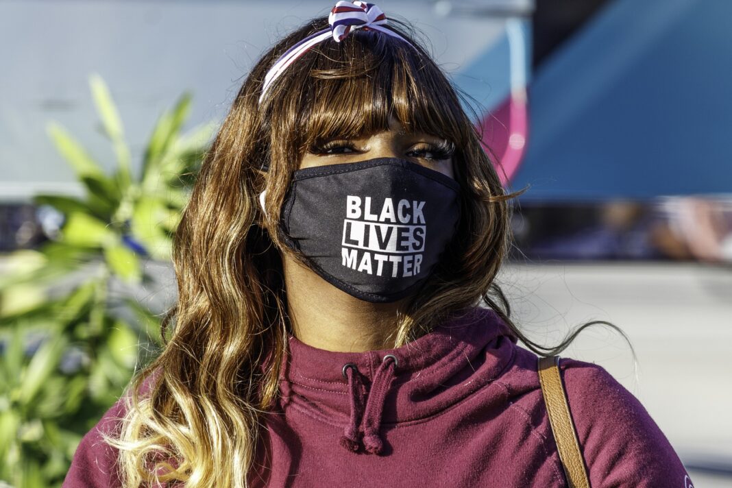 Mujer afroamericana con una mascarilla del movimiento Black Lives Matter